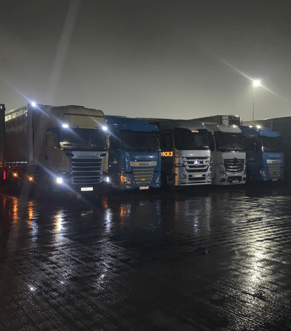 Lorries parked up in a line at night