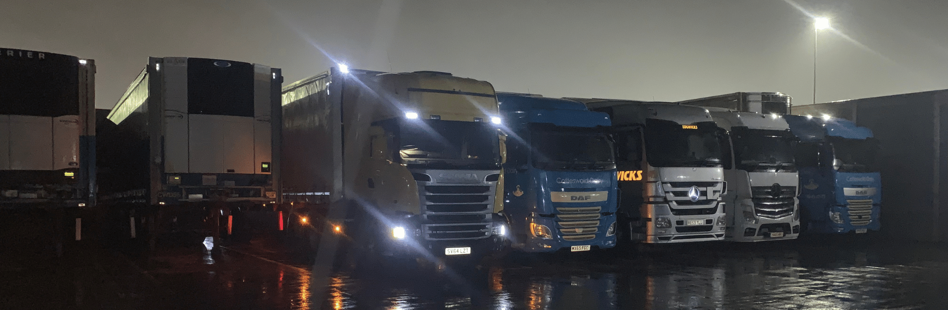 Line of stationary lorries at night