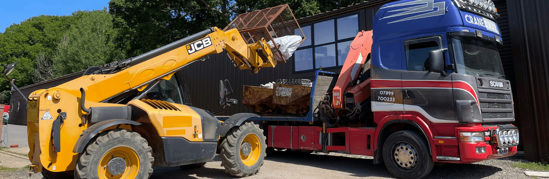 A Hiab being loaded by a yellow forklift